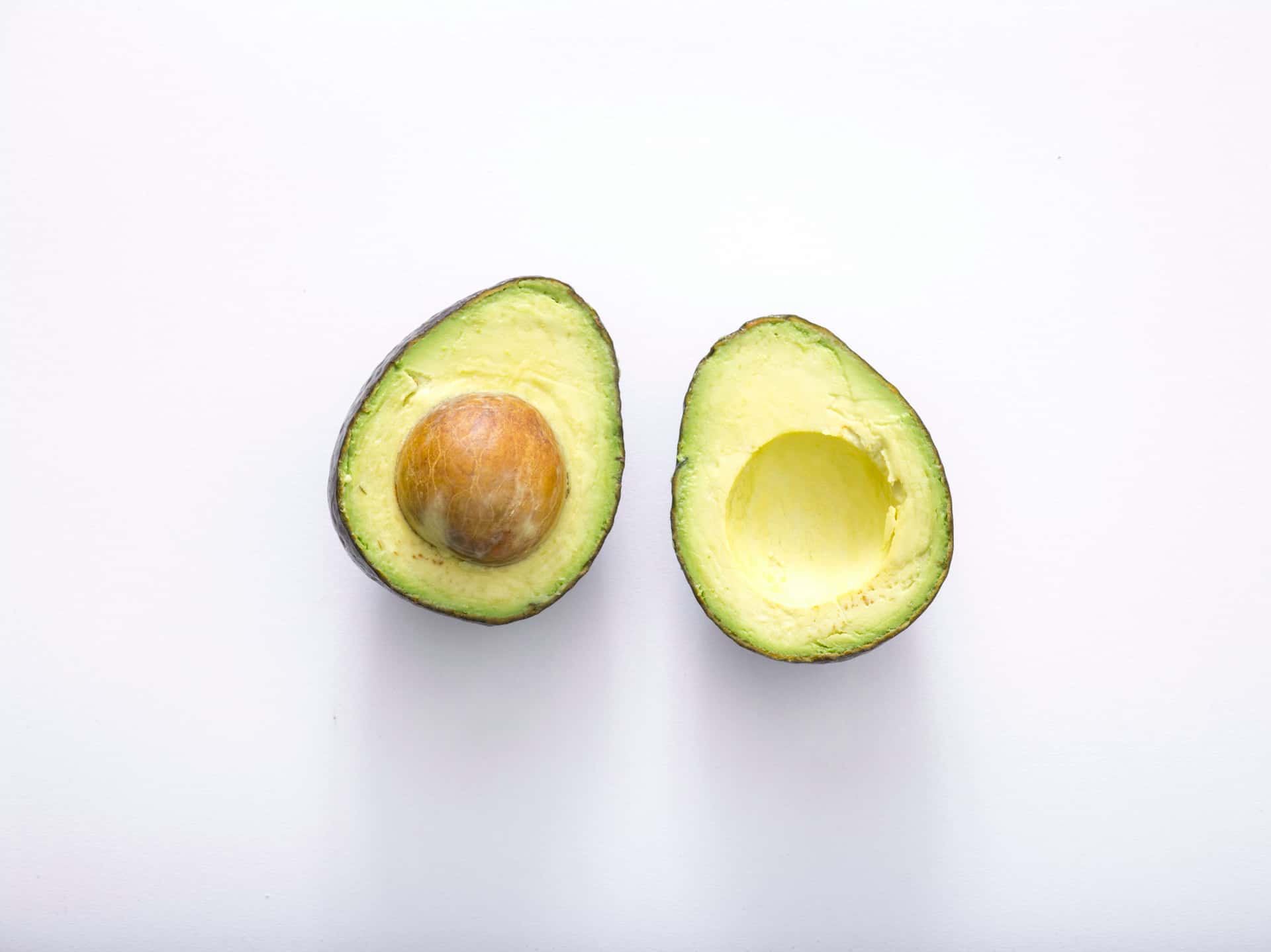 An avocado sliced in half